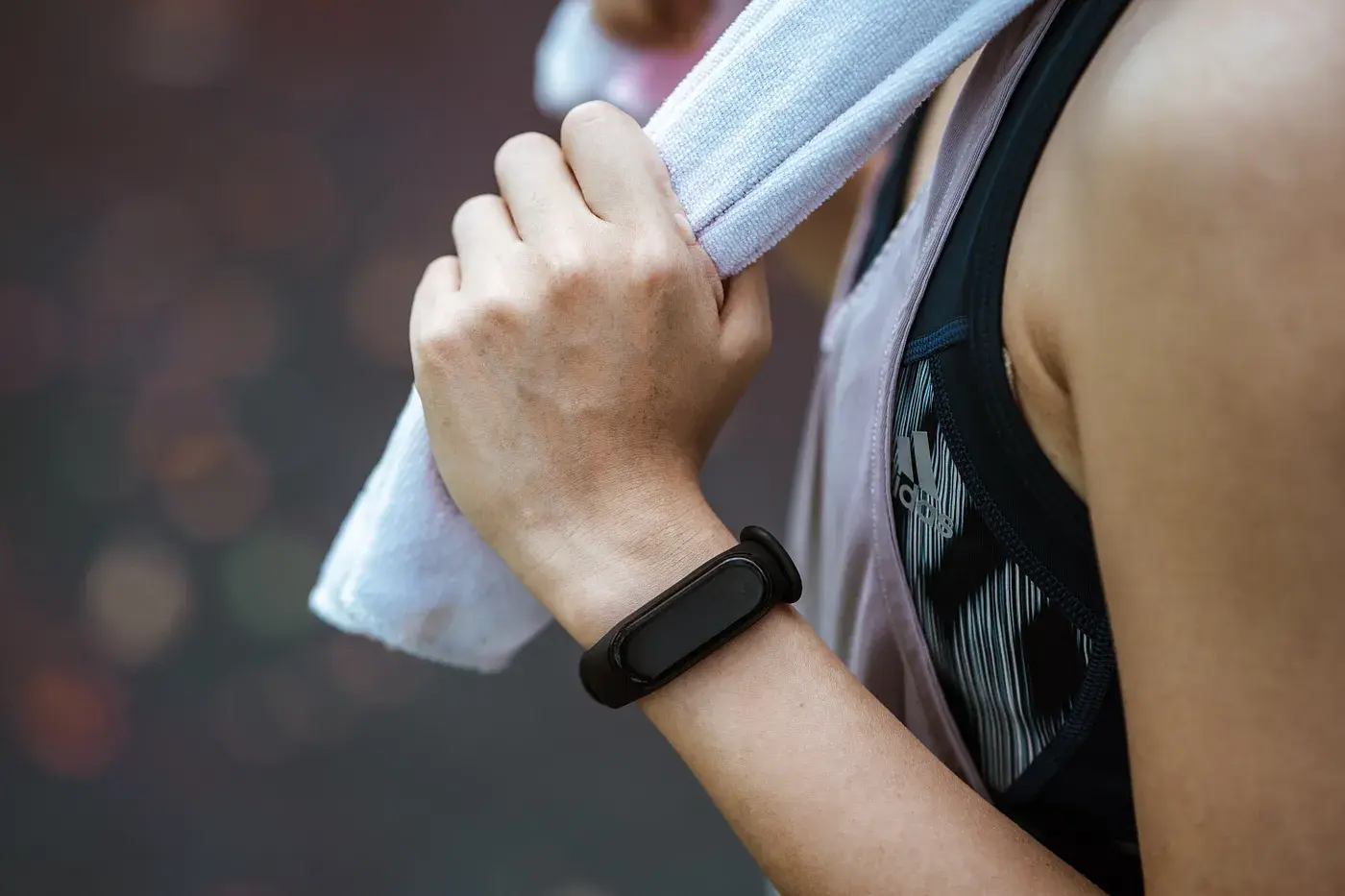 Lifestyle product photography showing a person using a smartwatch while jogging